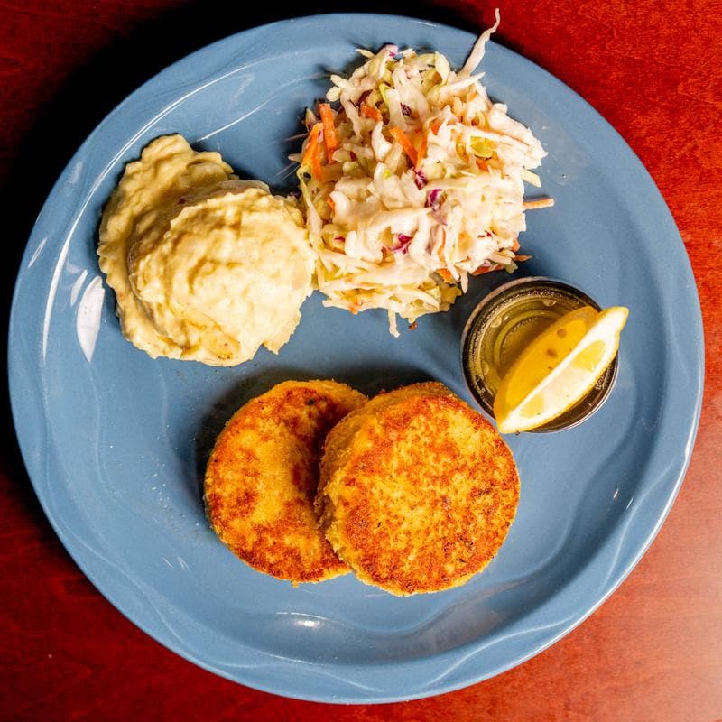 Crab cakes with potato salad and coleslaw