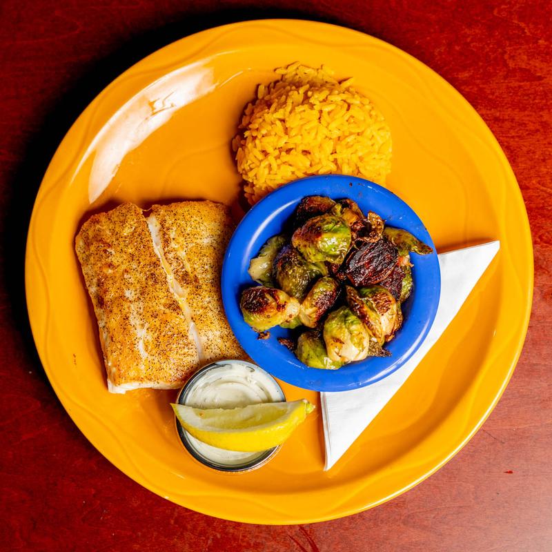 Grilled fish fillet with crispy brussels sprouts and rice